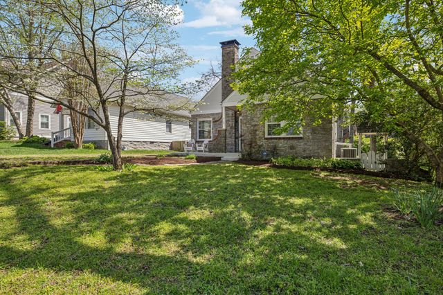 a living room with furniture a rug and a chandelier