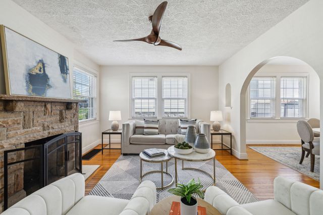 a kitchen with stainless steel appliances white cabinets and wooden floors
