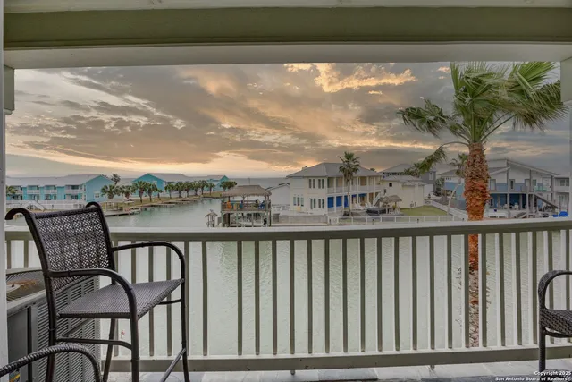 a view of a chair and table in the balcony