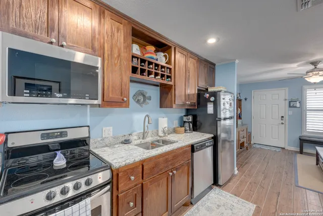 a kitchen with stainless steel appliances granite countertop a stove and a refrigerator