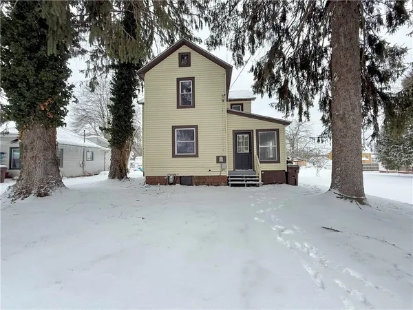a view of a house with a yard and garage