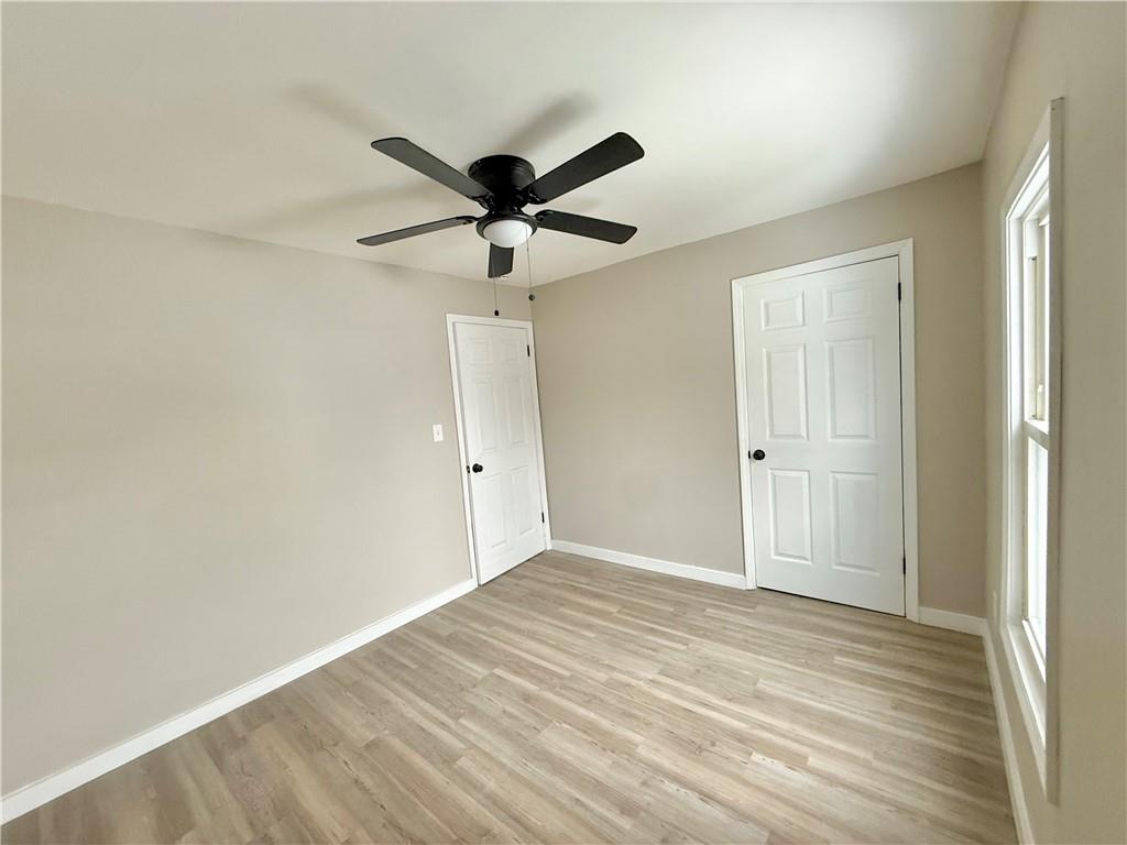 570 High Street Conneaut Lake, PA 16316 - Photo 15 of 26 a view of a big room with wooden floor and a ceiling fan
