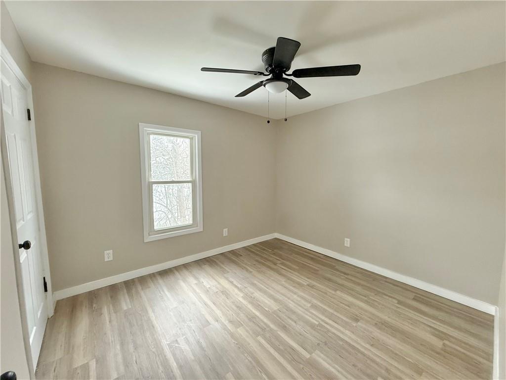 570 High Street Conneaut Lake, PA 16316 - Photo 16 of 26 wooden floor in an empty room with a window