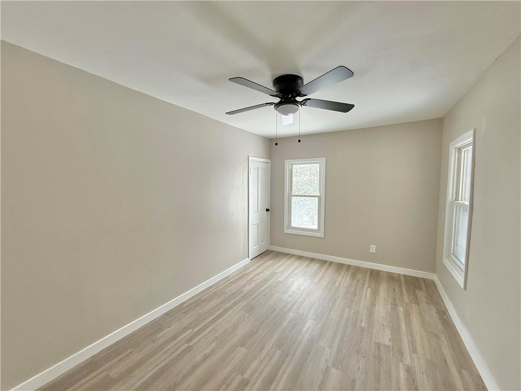 570 High Street Conneaut Lake, PA 16316 - Photo 17 of 26 wooden floor in an empty room with a window