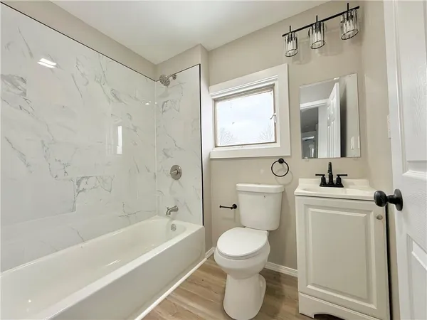a bathroom with a toilet sink and shower