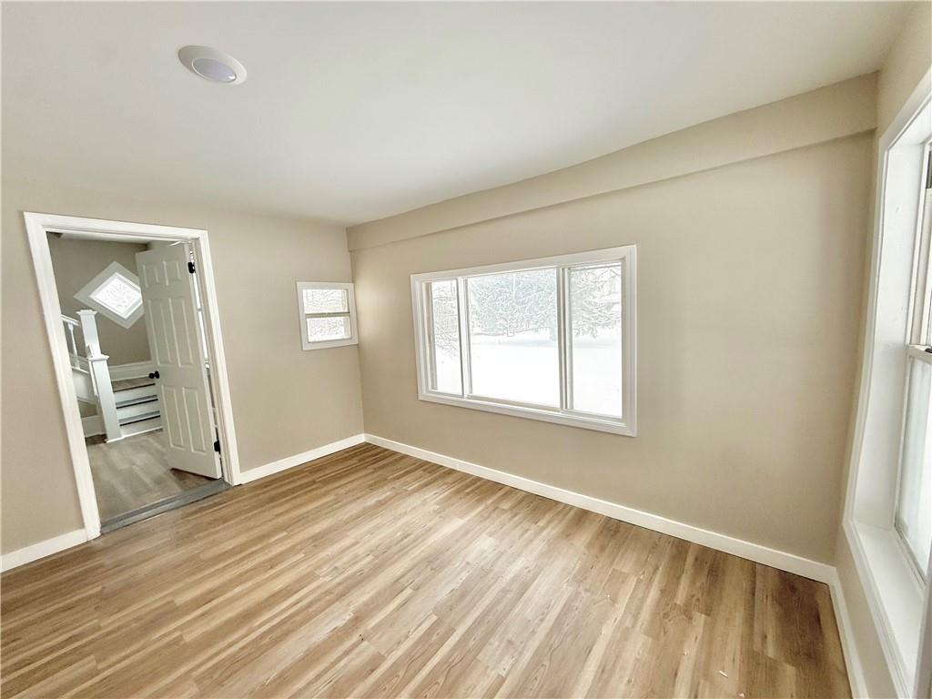 570 High Street Conneaut Lake, PA 16316 - Photo 2 of 26 wooden floor in an empty room with a window
