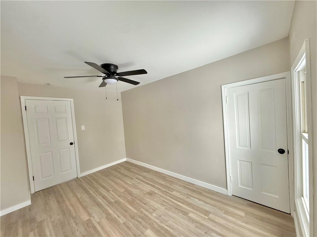 570 High Street Conneaut Lake, PA 16316 - Photo 21 of 26 a view of empty room with wooden floor and ceiling fan