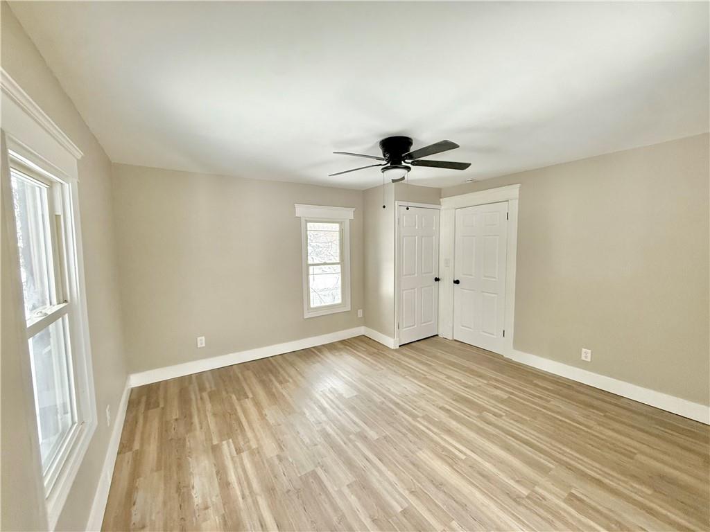 570 High Street Conneaut Lake, PA 16316 - Photo 22 of 26 a view of an empty room with a window and wooden floor