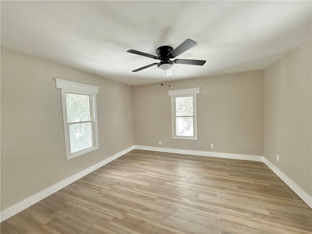 570 High Street Conneaut Lake, PA 16316 - Photo 23 of 26 a view of an empty room with a window and wooden floor
