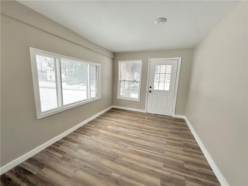 570 High Street Conneaut Lake, PA 16316 - Photo 3 of 26 a view of an empty room with wooden floor and a window