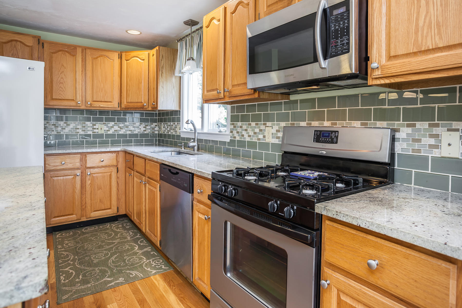 97 Shields Road Mashpee, MA 02649 - Photo 12 of 31 a kitchen with a stove and a microwave