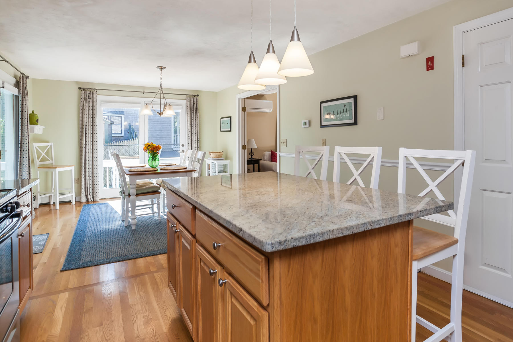 97 Shields Road Mashpee, MA 02649 - Photo 13 of 31 a kitchen with granite countertop a table chairs stove and wooden floor