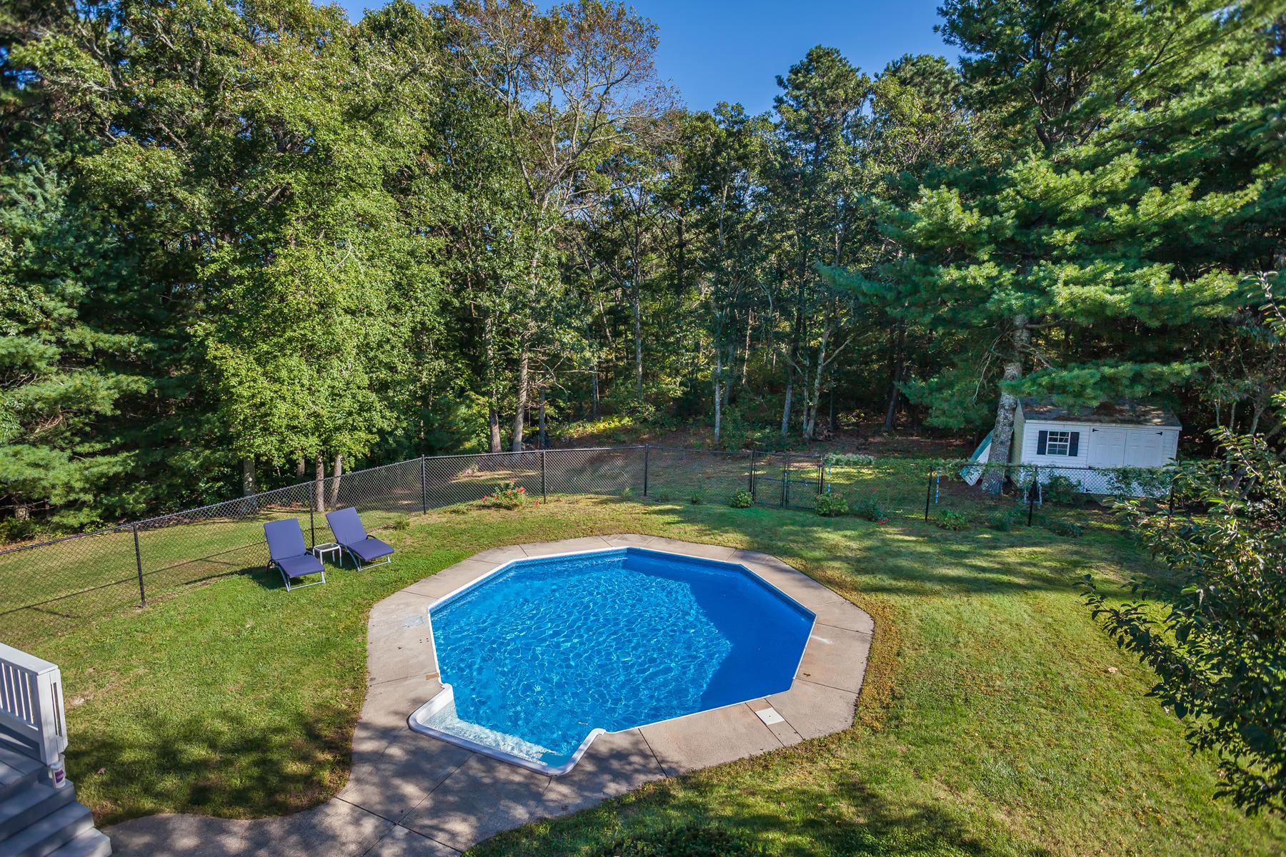 97 Shields Road Mashpee, MA 02649 - Photo 20 of 31 a view of a swimming pool with a yard and sitting area