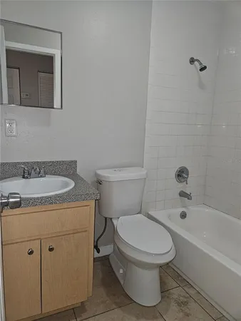 a bathroom with a toilet a sink and bathtub