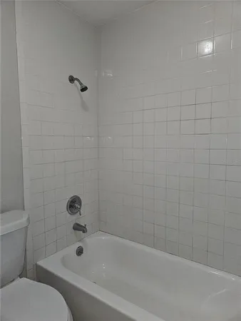 a bathroom with a bathtub and toilet