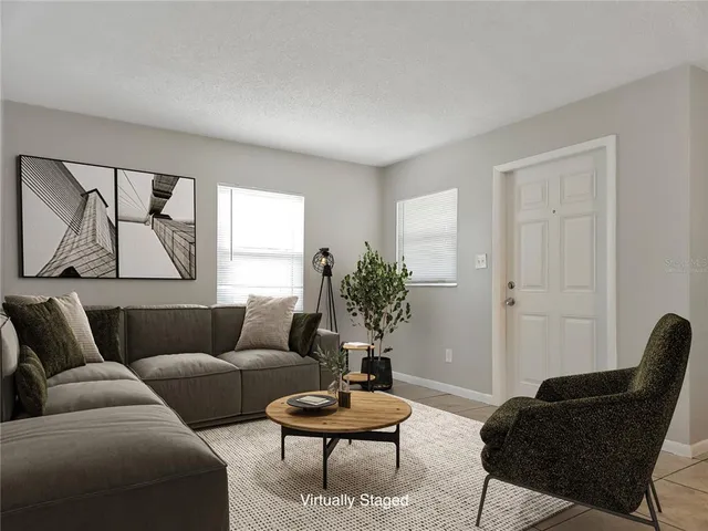 a living room with furniture and a potted plant