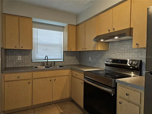 a kitchen with a sink stove and cabinets