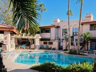 10410 North Cave Creek Road, Unit 2043 Phoenix, AZ 85020 - Photo 3 of 22 a view of a house with a swimming pool