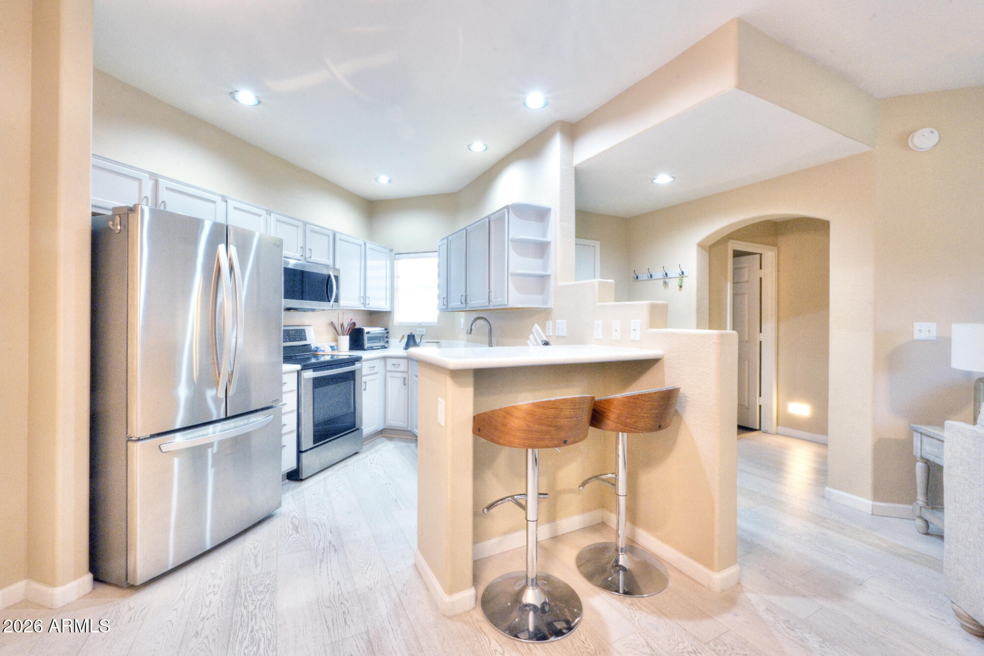 10410 North Cave Creek Road, Unit 2043 Phoenix, AZ 85020 - Photo 5 of 22 a kitchen with stainless steel appliances granite countertop a refrigerator and a sink