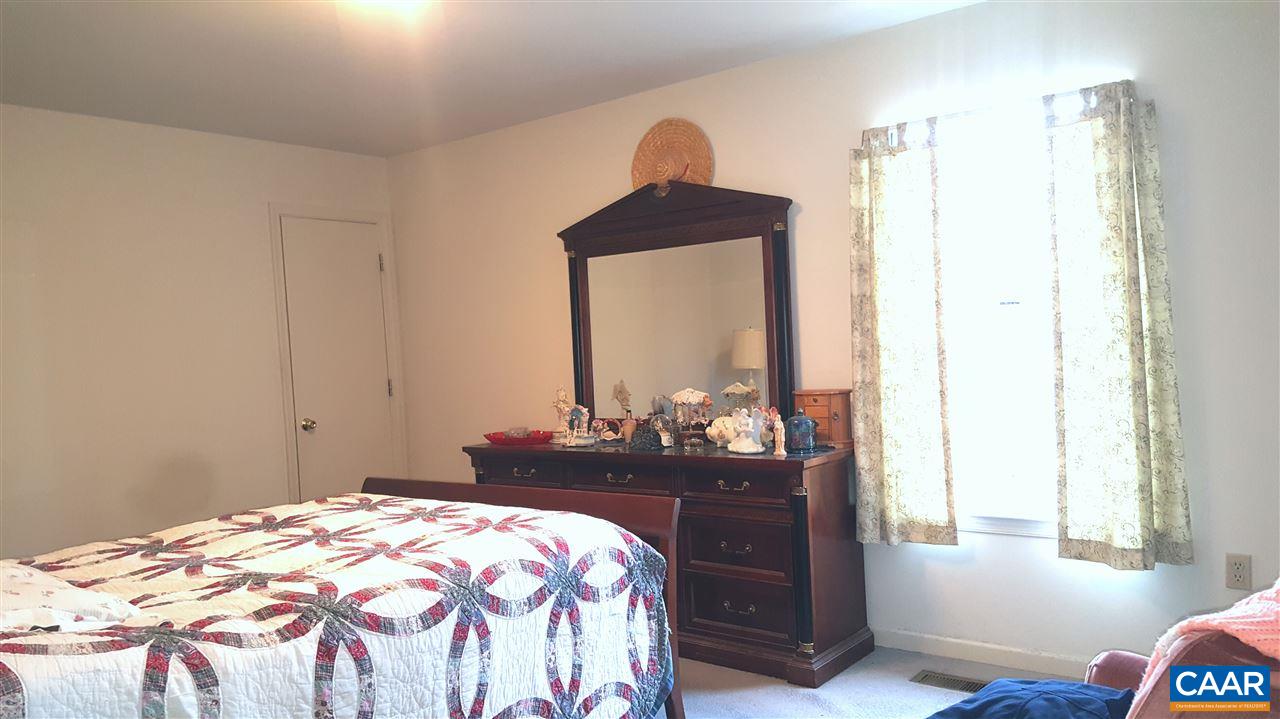 25 Poppy Road Ruckersville, VA 22968 - Photo 15 of 32 a bedroom with a bed and a dresser