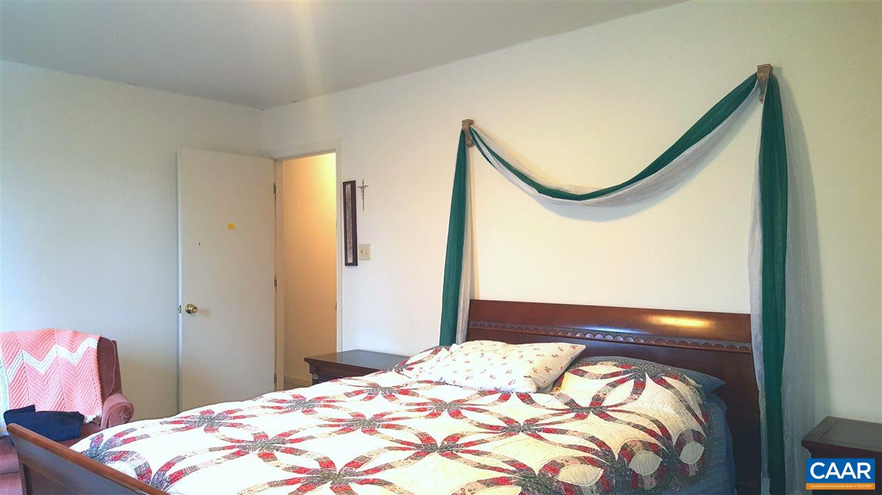 25 Poppy Road Ruckersville, VA 22968 - Photo 18 of 32 a bedroom with a bed and a mirror