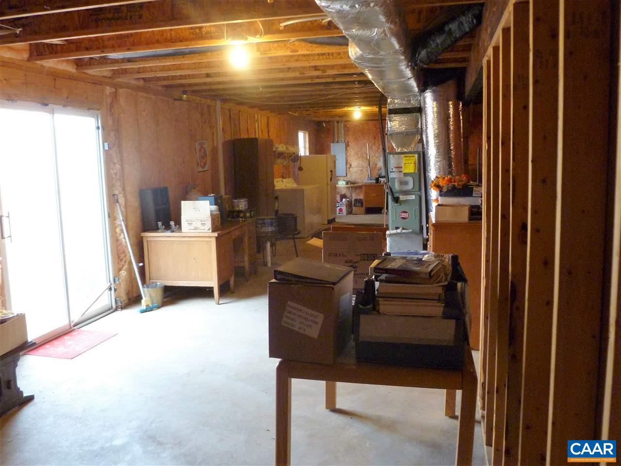 25 Poppy Road Ruckersville, VA 22968 - Photo 25 of 32 a living room with furniture and a chandelier