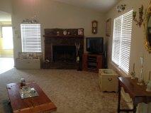 The large living room features a wood burning fireplace.