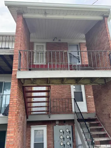 a view of a chairs and table in the balcony