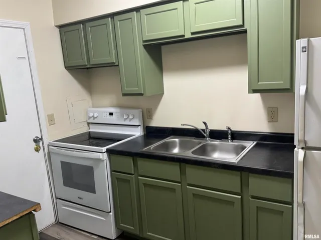 a kitchen with a sink and cabinets