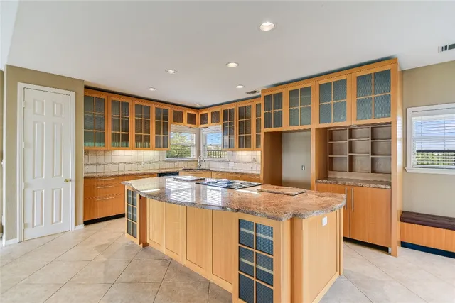 a kitchen with stainless steel appliances granite countertop a sink and a refrigerator