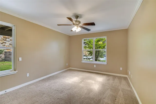 a view of a room with window and ceiling fan