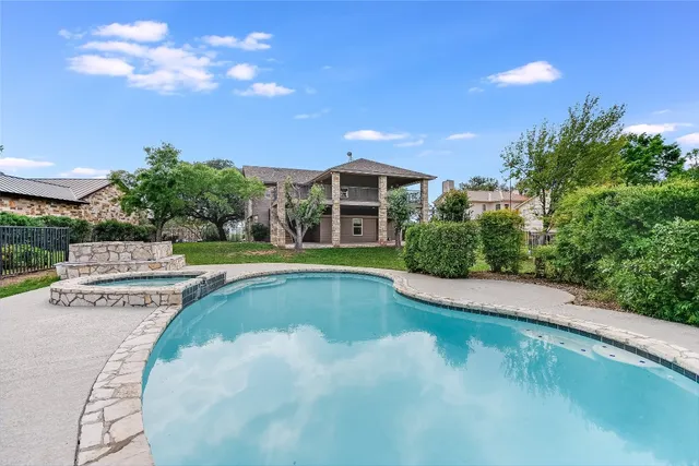 a view of a swimming pool with a yard