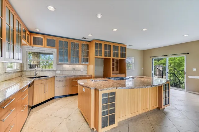 a kitchen with stainless steel appliances granite countertop a stove and a sink