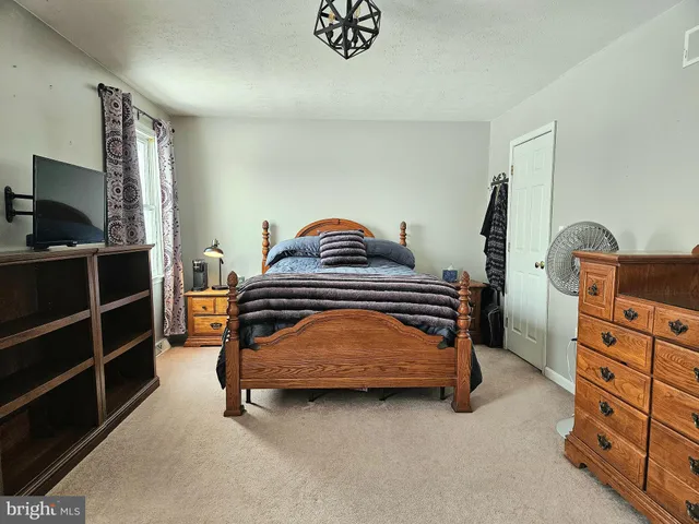 a bedroom with a bed and a television