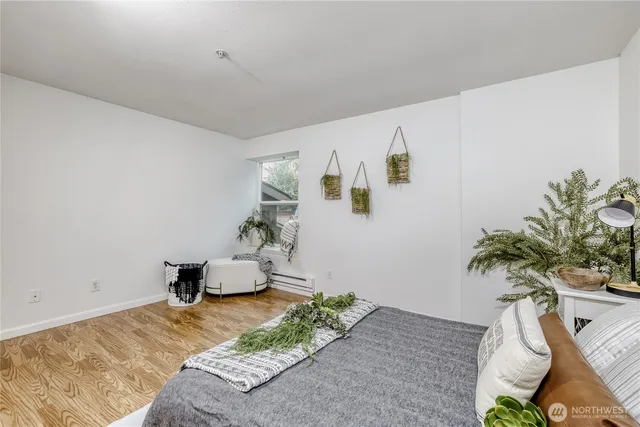 a bedroom with a bed and a potted plant