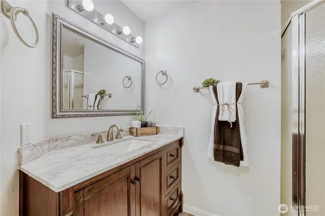 a bathroom with a sink vanity and a mirror