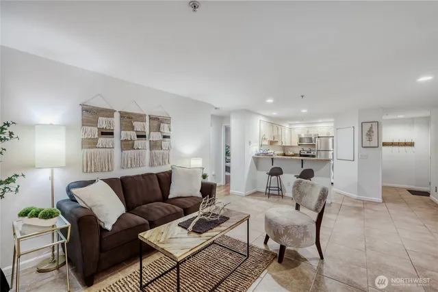 a living room with furniture and kitchen view