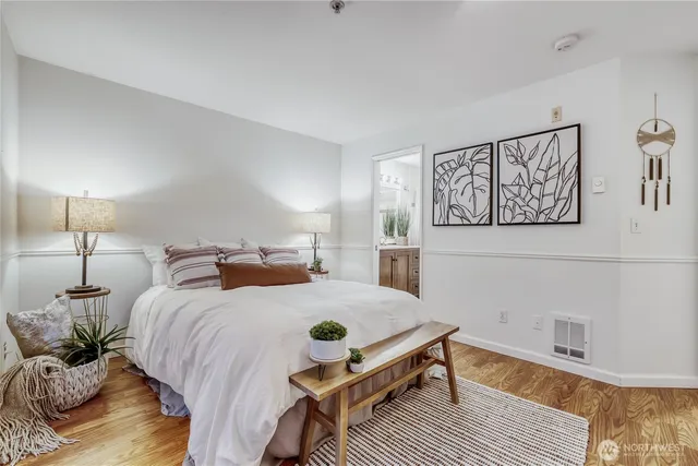 a bedroom with a bed and wooden floor