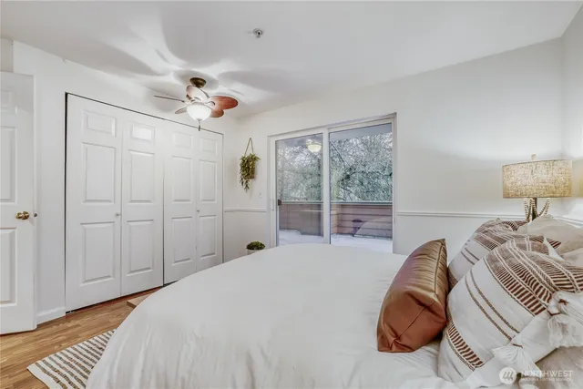 a bedroom with a large bed and a chandelier