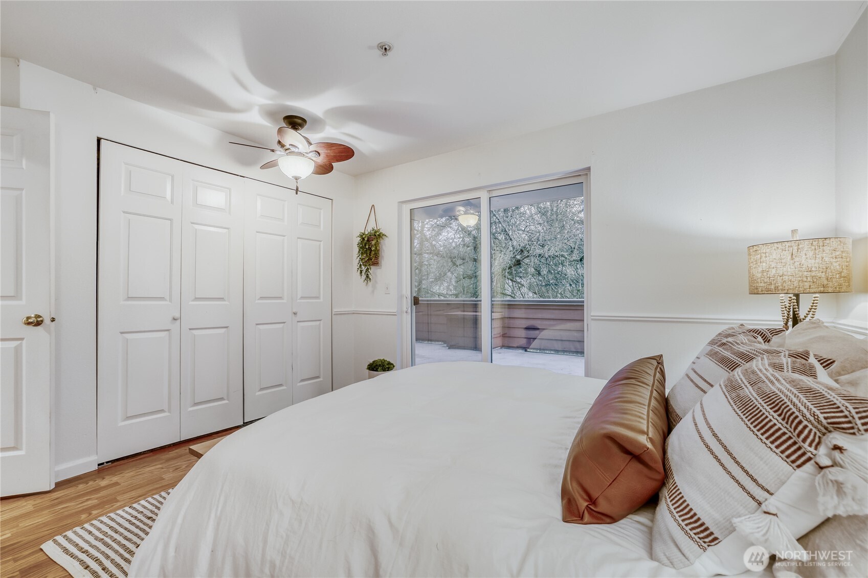 15805 Waynita Way Northeast, Unit D107 Bothell, WA 98011 - Photo 9 of 18 a bedroom with a large bed and a chandelier