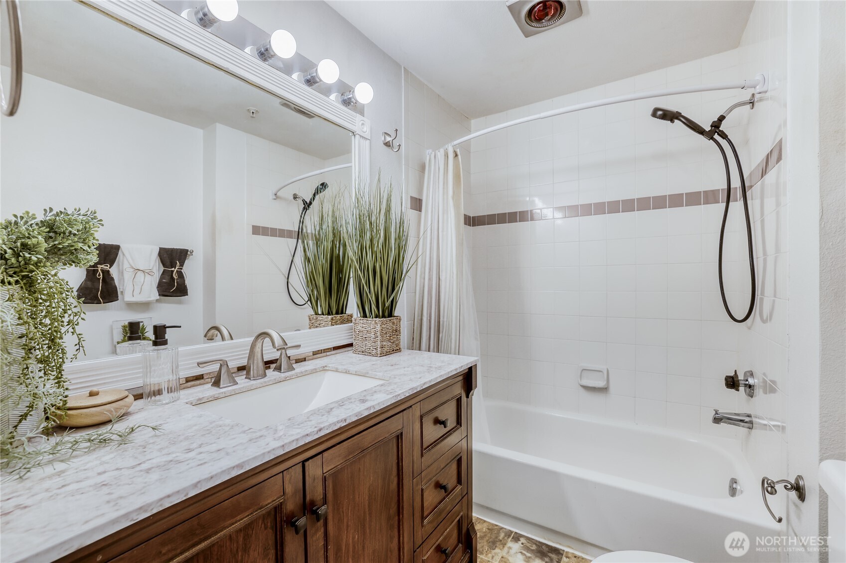 15805 Waynita Way Northeast, Unit D107 Bothell, WA 98011 - Photo 10 of 18 a bathroom with a granite countertop sink a mirror and a bathtub