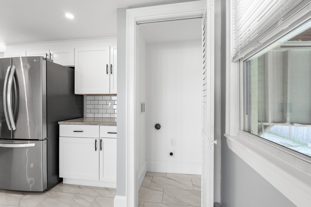 212 Cambridge Road Woburn, MA 01801 - Photo 12 of 25 a kitchen with stainless steel appliances a refrigerator and a window