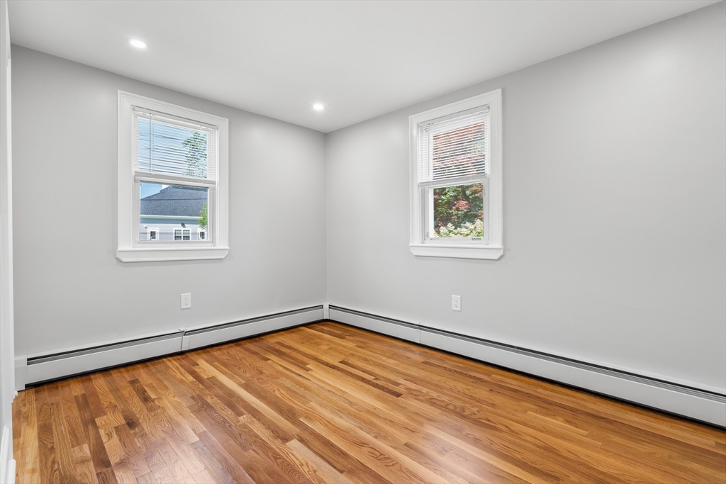 212 Cambridge Road Woburn, MA 01801 - Photo 17 of 25 a view of a big room with wooden floor and windows