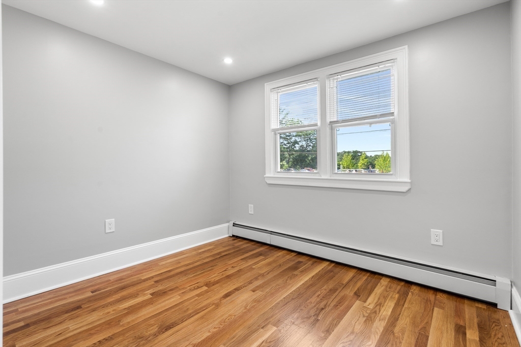212 Cambridge Road Woburn, MA 01801 - Photo 18 of 25 wooden floor in an empty room with a window