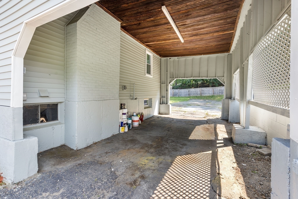 212 Cambridge Road Woburn, MA 01801 - Photo 25 of 25 a view of a porch with a table and chairs and floor to ceiling window