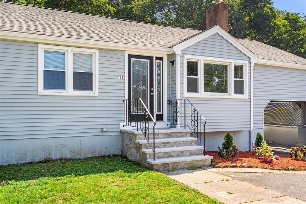 212 Cambridge Road Woburn, MA 01801 - Photo 3 of 25 a front view of a house with a yard