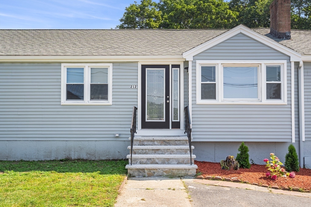 212 Cambridge Road Woburn, MA 01801 - Photo 4 of 25 a front view of a house with a yard