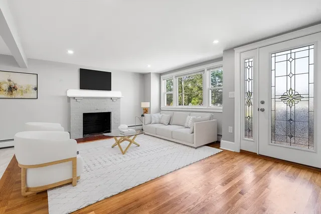 a living room with furniture a window and a fireplace