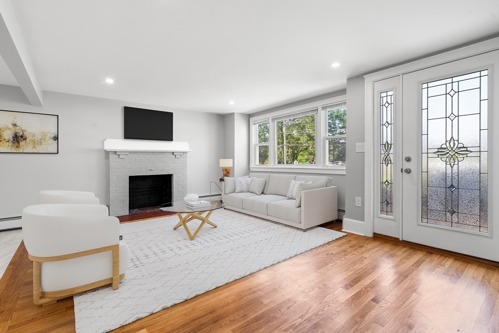 212 Cambridge Road Woburn, MA 01801 - Photo 8 of 25 a living room with furniture a window and a fireplace