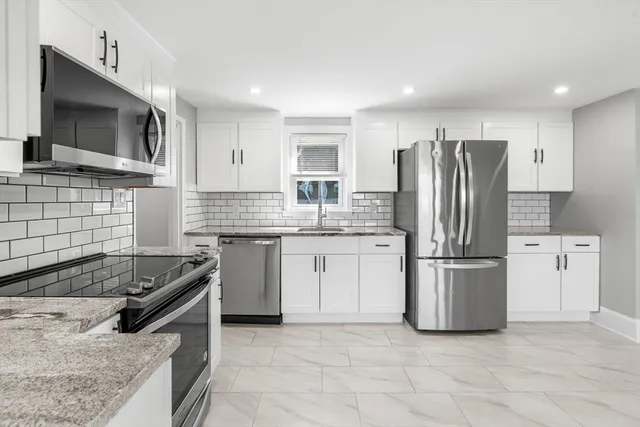 a kitchen with a refrigerator stove and microwave